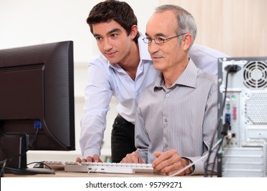 Computer Technician Helping Office Worker