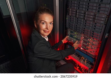 Computer technician working with backup server in racks - Powered by Shutterstock - Get 15% off with code: PIKWIZARD15