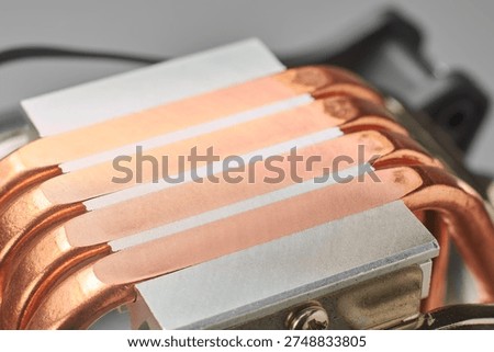 computer tower cpu cooler base with exposed copper heat pipes, integrated into silver metal block, closeup soft focus, pc cooling technology concept