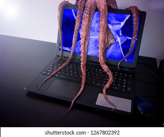 Computer virus concept. Laptop with broken screen seized by disgusting monster with long sticky tentacles.