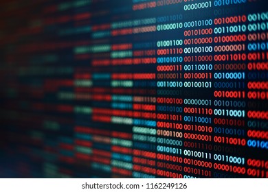Computer virus infection. Rows of binary codes randomly colored red and blue on black screen monitor background. Corrupted computer data bad sector hard disk visualization.