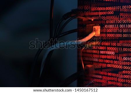 computer virus transfer into desktop pc by internet LAN line. double exposure shot of backside of a computer and red binary codes. hacker virus spyware ransomware and security breached concepts.