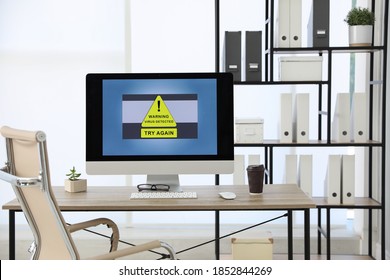 Computer with warning about virus attack on screen in office