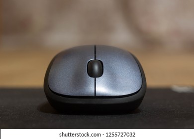 Computer Wireless Mouse Close Up On A Black Mousepad