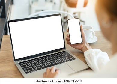 computer,cell phone mockup image blank screen with white background for advertising text,hand woman using laptop texting mobile contact business search information on desk in cafe.marketing,design - Powered by Shutterstock