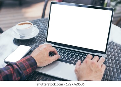 computer,cell phone mockup image blank screen with white background for advertising,hand man work using laptop texting mobile contact business search information on desk in cafe.marketing,design