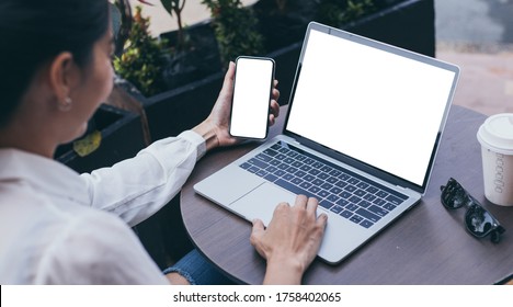 computer,cell phone mockup image.hand woman work using laptop texting mobile.blank screen with white background for advertising,contact business search information on desk in cafe.marketing,design - Shutterstock ID 1758402065