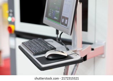 Computerized control console on support arm system. Automatic industrial equipment. Selective focus.