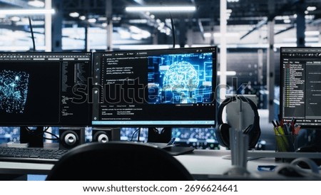 Computers in data center supporting AI training workflows and automated infrastructure systems. PC screens in high tech facility tracking servers hardware processing machine learning datasets