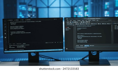 Computers in empty data center facility managing rackmounts energy consumption. Close up of script on PC monitors used for automation and monitoring processes in server room, camera B
