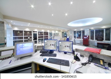 Computers Of Security Guards In Reception Area In Office Building.