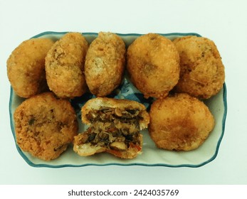 Comro (Sundanese: Comro lakuran of oncom di jero, lit. "Oncom inside") is a typical Sundanese fried food. Comro is made from grated cassava which is shaped round or oval and filled with oncom and chil