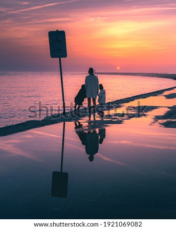 Comtemplating the sunset near the sea.