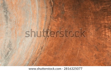 Concave copper surface with round rings of patina. Wear and natural Oxidation. Shallow depth of field. Copy space. Design background.