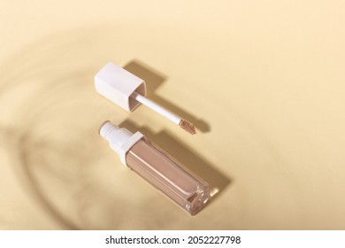 Concealer Cream On A Background With Shadows. Face Corrector On Beige Background With Copy Space. Blank Mockup For Product