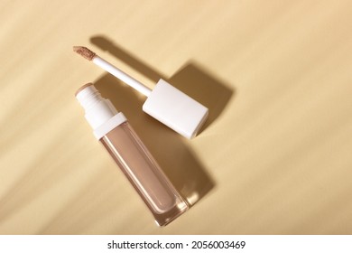 Concealer Cream On A Background With Shadows. Face Corrector On Beige Background With Copy Space. Blank Mockup For Product