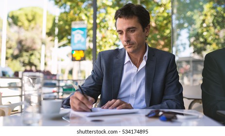 concentrate middle age businessman portrait writing stock photo concentrate middle age businessman portrait writing an essay outdoors in rome italy