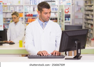 Concentrate Pharmacist Using Computer At The Hospital Pharmacy