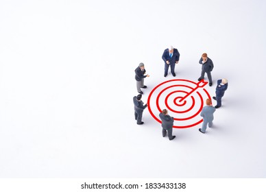 Concentrate Setup Objectives Target And Business Goal ,Manager Miniature Figures Standing And See In Virtual Red Arrow And Dartboard Which Print Screen On White Background.