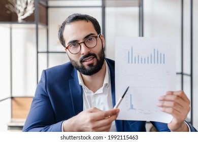 Concentrated Arabian Muslim Businessman Tutor Lecturer Conducting Online Lectures Meeting, Showing Charts And Graphs, Zoom Video Call On Remote Occupation, Boss Explaining Project Data Results