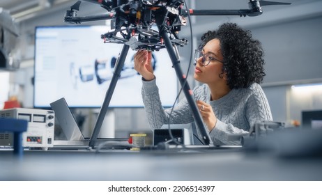 Concentrated Black Female Engineer Writing Code. Developing Software for Modern Drone Control in the Research Center Laboratory. Technological Breakthrough in Flight Industries Concept.