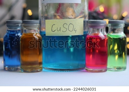 Concentrated blue water solution of copper sulfate in a glass bottle.