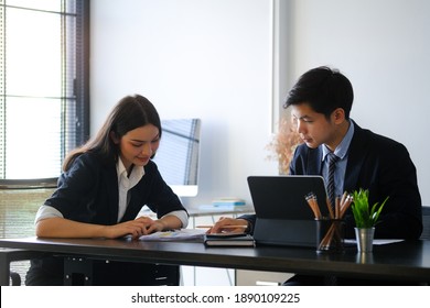 Concentrated business people or employees using tablet computer consider project or startup in office.