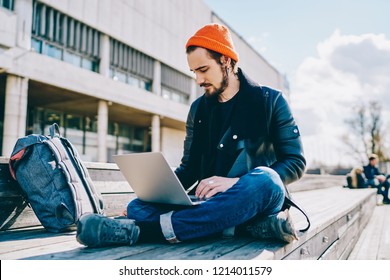 Concentrated Caucasian Student Typing On Laptop Computer Learning Online While Sitting Outdoors On Urban Setting, Skilled Male Freelancer Checking Mail And Notification About Business On Netbook