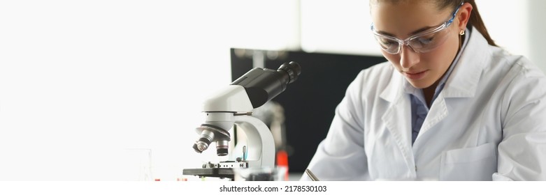 Concentrated Chemist Worker Write Down Thoughts On Investigation Project In Lab