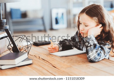 Similar – Image, Stock Photo happy school girl doing homework. Smart child working hard