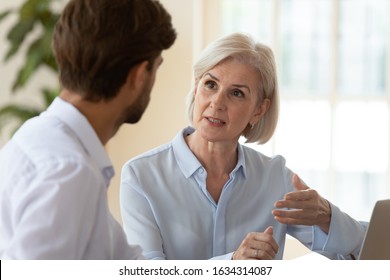 Concentrated diverse businesspeople talk brainstorm at meeting in office share thoughts, focused man and woman colleagues discuss ideas work together cooperating at briefing, collaboration concept - Powered by Shutterstock