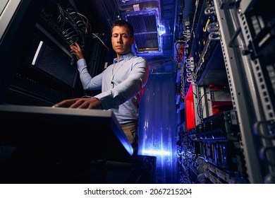 Concentrated engineer installing operating system on physical server