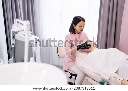 Concentrated female beautician doing massage to client
