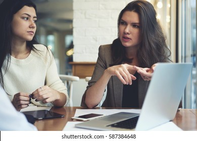 Concentrated Female Correspondents Having Informal Meeting During Work Break In Coffee Shop Discussing Task For Day From Editor Preparing For Meet With Government Officials And Conduct Interviews 