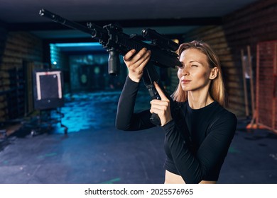 Concentrated Female Shooter Looking Into The Rifle Bore