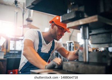 Concentrated look. Man in uniform works on the production. Industrial modern technology. - Shutterstock ID 1488064718