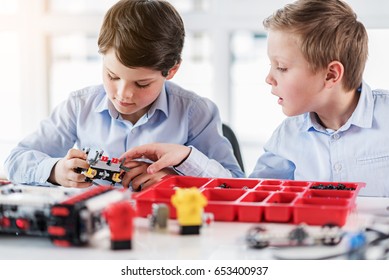 Concentrated Male Children Keeping Lego