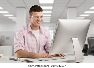 Concentrated Male Small Business Owner Looking At The Computer Screen While Sitting In Modern Office.