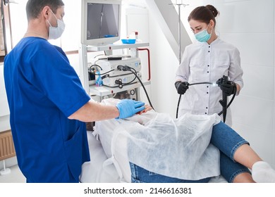 Concentrated man calming his patient before the gastroscopy at the modern clinic