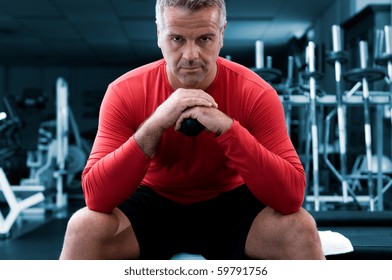 Concentrated Mature Man Looking At Camera At Gym