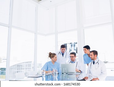 Concentrated medical team using laptop together in the office