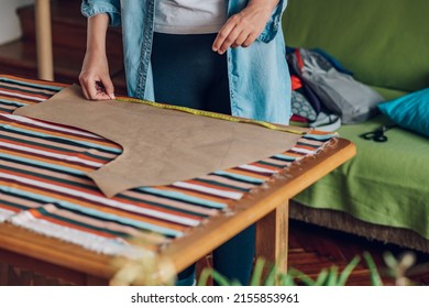 Concentrated Middle Aged Woman Tailor Making Pattern Dress Detail On Sketch Lines For Sewing Machine. Workplace Of A Dressmaker. Handmade Concept. Focus On Tailors Hands And Meter.