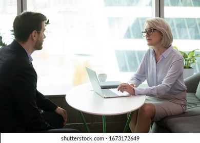 Concentrated Middle-aged Businesswoman Head Meeting With Male Business Partner In Office, Serious Mature Female CEO Or Boss Listen To Job Applicant During Work Interview, Employment, Hiring Concept