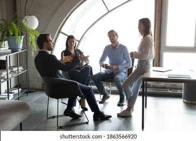 Concentrated Millennial Male Ceo Leader Setting Targets To Staff Workforce Members On Daily Briefing In Modern Office, Young Business Partners Colleagues Sitting In Circle Planning Teamwork On Meeting