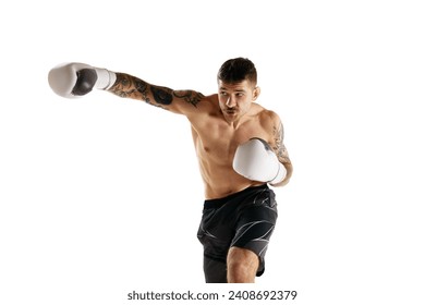 Concentrated muscular shirtless young man, boxing athlete in motion, training isolated over white background. Concept of professional sport, combat sport, martial arts, strength - Powered by Shutterstock