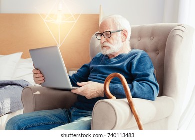 Concentrated Pensioner Looking At Screen Of Computer