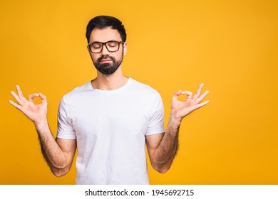 Concentrated Relaxed Person, Standing With Closed Eyes, Having Relaxation While Meditating, Trying To Find Balance And Harmony. Yoga And Meditation Concept. Isolated Over Yellow Background.