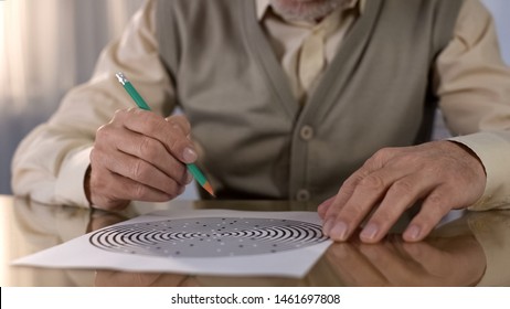 Concentrated Retired Man Solving Logic Test At Table, Memory Exercise, Neurology