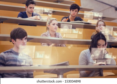 Concentrated students in lecture hall working on their futuristic tablet during lesson - Powered by Shutterstock