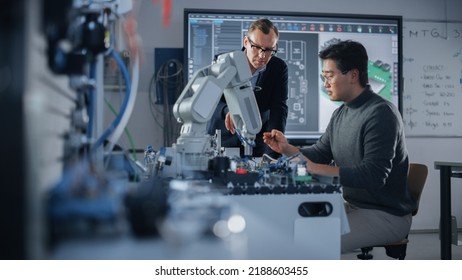 Concentrated Teacher Helping Asian Engineer Student Working with Screwdriver and Computer Motherboard. Science, Robotics and Engineering Concept at Modern University of Technology. Medium Shot - Shutterstock ID 2188603455